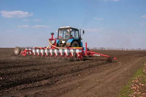 Tractor with sower on the field Stock Photos
