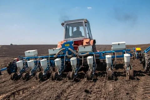 Tractor with sower on the field Foto stock