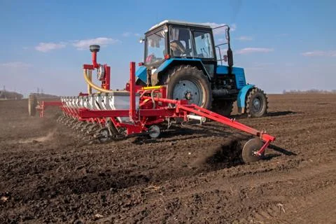 Tractor with sower on the field Stock Photos
