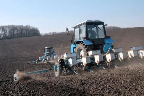 Tractor with sower on the field Stock Photos