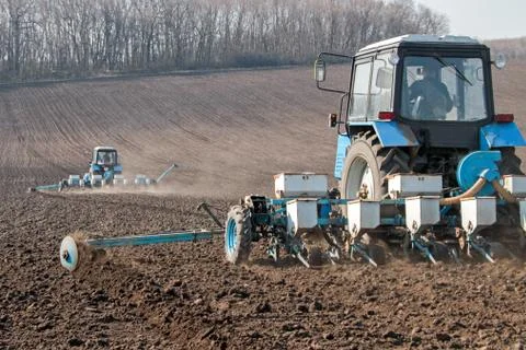 Tractor with sower on the field Stock Photos