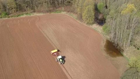 Tractor sowing crop on spring farm field, aerial view Stock Footage 89824070