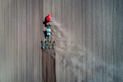 Tractor sowing in the field Stock Photos