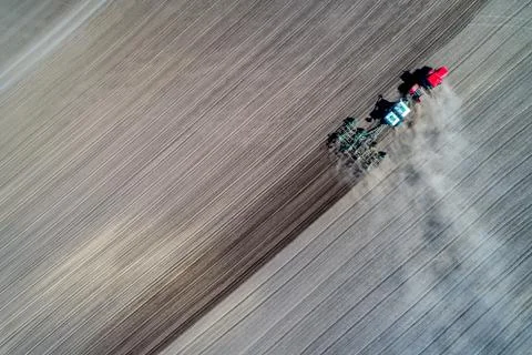 Tractor sowing in the field Stock Photos