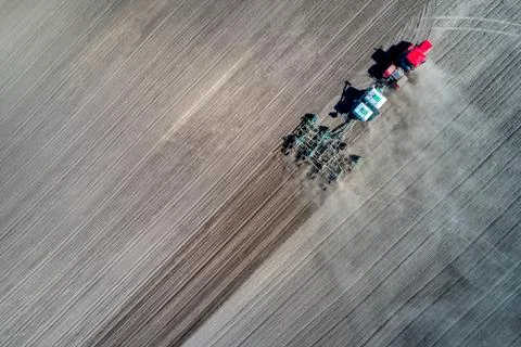 Tractor sowing in the field Stock Photos
