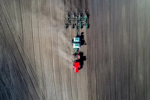 Tractor sowing in the field Stock Photos