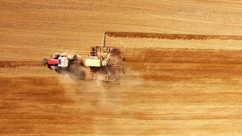 Tractor with sowing machine working on a  field. Stock Footage 105862065