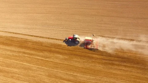 Tractor with sowing machine working on a  field. Stock Footage 105862929