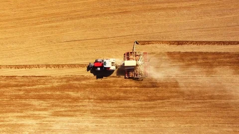 Tractor with sowing machine working on a  field. Stock Footage 105863851