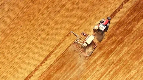 Tractor with sowing machine working on a  field. Stock Footage 105864217