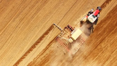 Tractor with sowing machine working on a  field. Stock Footage 105864268