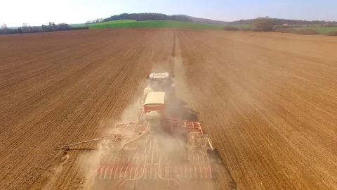 Tractor with sowing machine working on a  field. Video stock 105864540