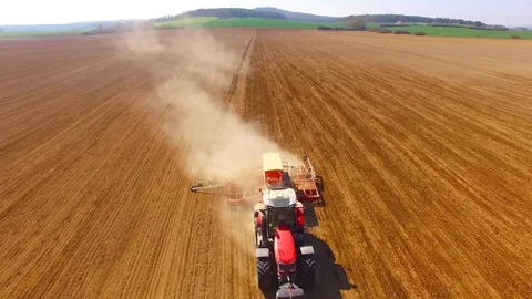 Tractor with sowing machine working on a  field. Video stock 105868099