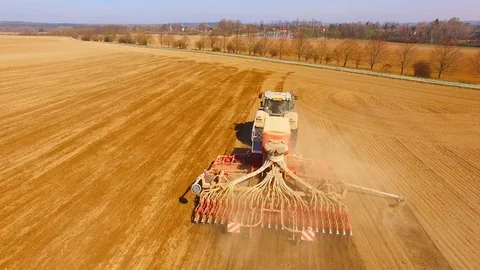 Tractor with sowing machine working on a  field. Video stock 105868720
