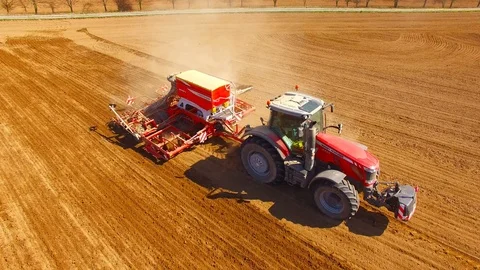 Tractor with sowing machine working on a  field. Video stock 105868877
