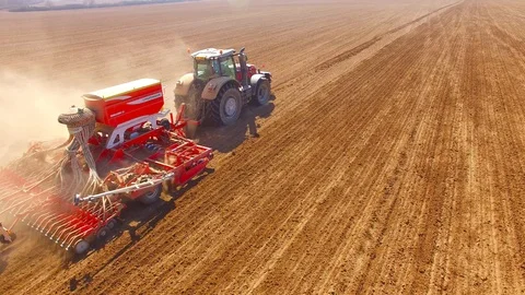 Tractor with sowing machine working on a  field. Video stock 105869882