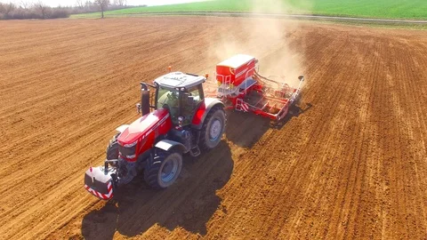 Tractor with sowing machine working on a  field. Video stock 105870294