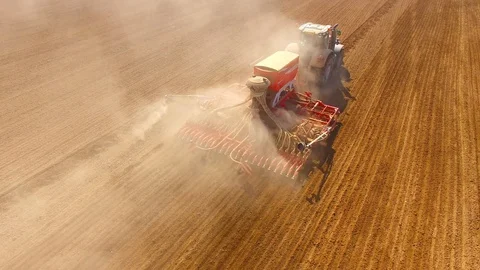 Tractor with sowing machine working on a  field. Video stock 105872196