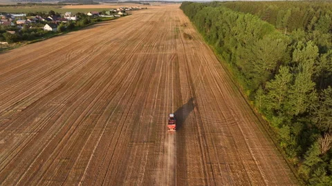Tractor sowing seed on plowed field. Farming and seeding 動画素材 208052725