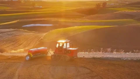 Tractor Sowing Seeds on Rolling Fields During Golden Hour Sichuan China Stock Footage 346424834