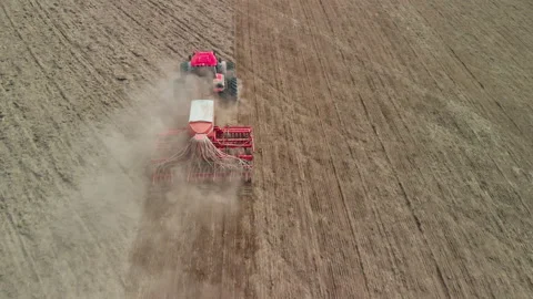 Tractor with a sowing unit sows grain crops Stock Footage 154835906