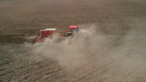 Tractor with a sowing unit sows grain crops 스톡 사진