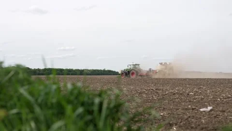 Tractor sows a field with soybeans from a seeder Video stock 275168329
