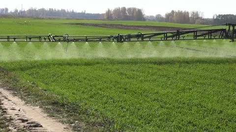 Tractor spray autumn crop field Stock Footage