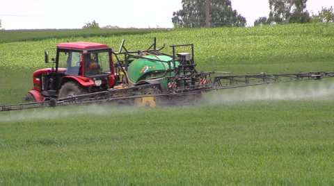 Tractor spray fertilizer cereal field for growth. agronomy work Stock Footage 44335077
