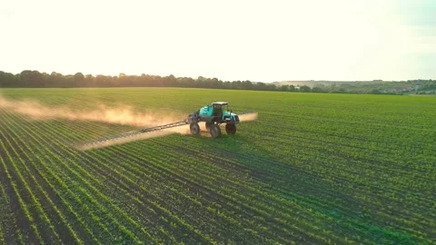 Tractor sprayer on soybean fields at sunset. Aerial drone footage. Ukraine - May Video stock 214724707