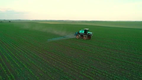 Tractor sprayer on soybean fields at sunset. Aerial drone footage. Ukraine - May 스톡 동영상 214725055