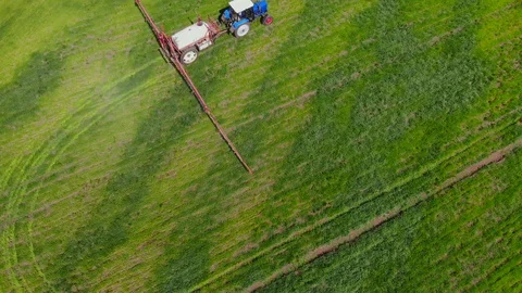 Tractor sprayer works in the field. Stock Footage 129666809