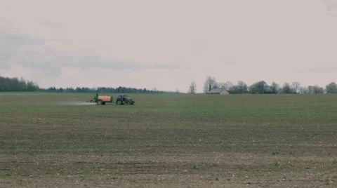 Tractor spraying field Stock Footage 49912565