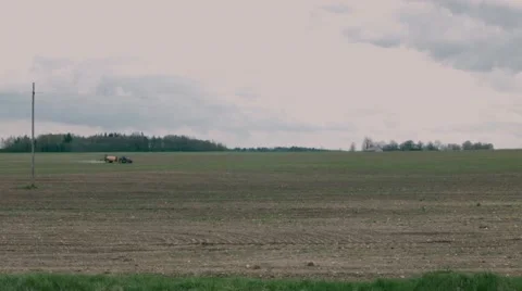 Tractor spraying field Stock Footage 49912567