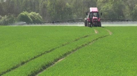 Tractor spraying fields Stock Footage 64985454