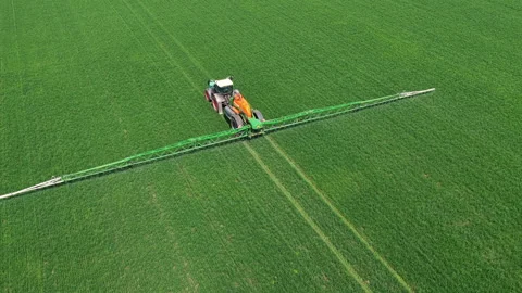 Tractor spraying a green field in Netherlands Stock Footage 342109222