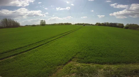 Tractor spraying wheat field, 4K Stock Footage 65453413