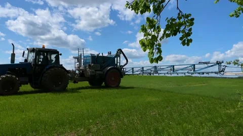 Tractor sprays fertilizer on the field Stock Footage 155296244