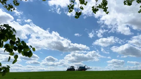 Tractor sprays fertilizer on the field Stock Footage 155296324