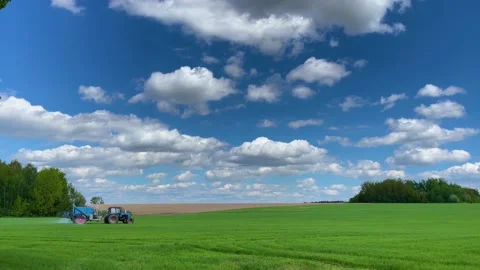 Tractor sprays fertilizer on the field Stock Footage 155296401