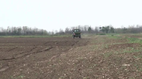 Tractor spreading fertilizer in springtime under a blue sky Video stock 37046951