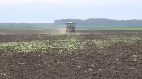 Tractor spreading fertilizer in springtime under a blue sky Video stock 37052297