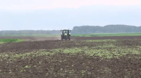 Tractor spreading fertilizer in springtime under a blue sky Stock-Footage 37056033