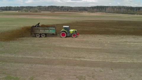 Tractor spreading manure on the field to increase fertility. Stock Footage 165557226