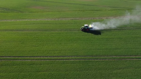 Tractor spreads fertilizer on spring wheat field, aerial Stock Footage 270769105