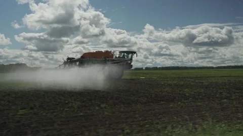 Tractor with sprinkler machine. Aerial drone view. 動画素材 317544720