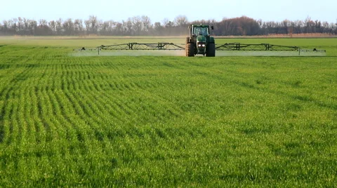 Tractor sprinkles the field Video stock 50087265