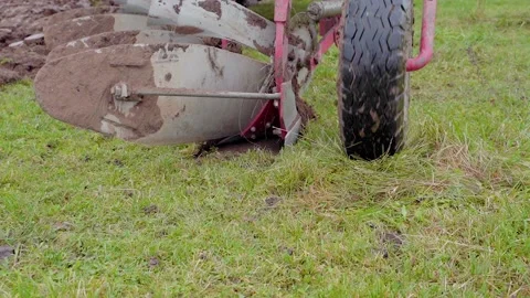 Tractor Start to Plow the Field - Low Angle Following Slow Motion Close up Stock Footage 144383045