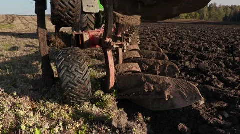 Tractor starts plowing field Stock Footage