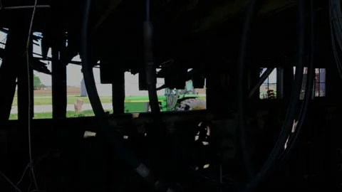 Tractor starts as seen from inside old barn Stock-Footage 205080126